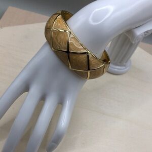Gold tone textured pattern enamel clamper hinge bracelet-statement style.